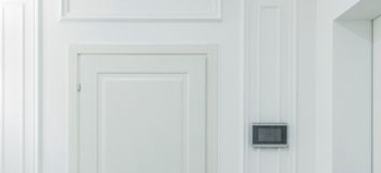 Custom trim and door casing example — white wainscot paneling detail